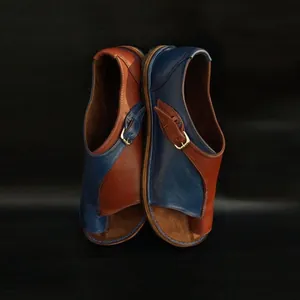 Close-up detail of stylish color-blocked leather flat sandals with adjustable buckle strap