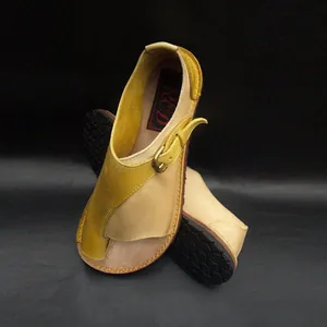 Detailed close-up of women's vintage patchwork leather flat sandals with buckle strap