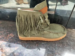 Side view of olive green suede fringe ankle boot with lace-up detail and thick sole