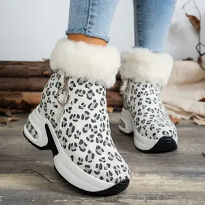 Close-up of leopard print snow boots with white faux fur trim and platform sole