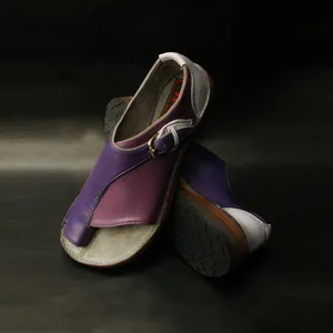 Detailed view of women's purple patchwork flat sandals with toe-loop and buckle