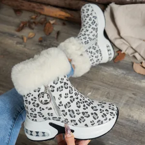 Detail of leopard print snow boots with white faux fur and platform air cushion sole.