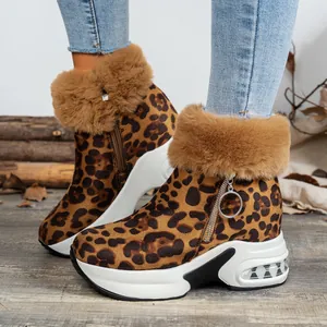 Close-up of leopard print snow boots with fluffy fur trim and platform air cushion sole.
