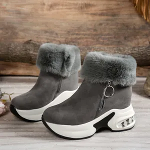 Detailed close-up of grey platform snow boots with faux fur trim and chunky wedge sole