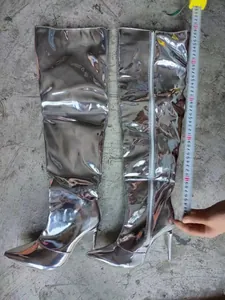 Silver mirror finish pointed toe over-the-knee boots showing a height measurement of 70cm