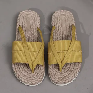 Detailansicht der gelben Stoffriemen und der geflochtenen Sohle dieser Strandsandalen
