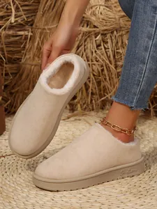Detailed view of beige women's snow boots featuring thick plush lining and soft faux suede