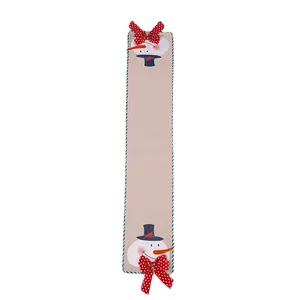 Festive Christmas linen table runner with cute snowman motifs and red polka-dot bows