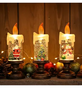 Drie decoratieve kerstsneeuwbol kaarslampen met vrolijke kerstman en sneeuwpop taferelen