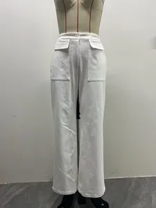 Detail view of white high-waisted corduroy wide-leg pants with dual utility pockets.
