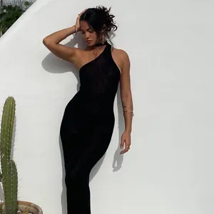 Full length view of a black one-shoulder bodycon maxi dress on model outdoors