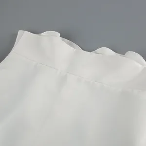 Close-up detail of the wave-edge stand collar on a white matte satin vintage shirt.