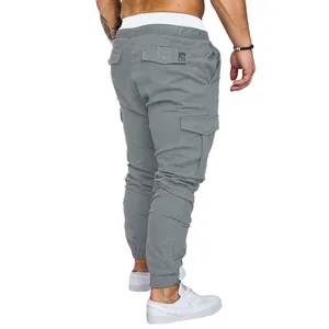 Rear view of grey men's multi-pocket cargo pants with tapered legs and elastic cuffs
