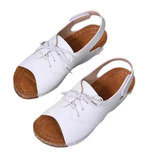 White peep-toe platform sandals featuring decorative laces and velcro straps for summer