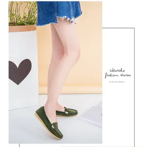 Elegant green suede flat loafers with metal buckle detail shown on model for casual wear