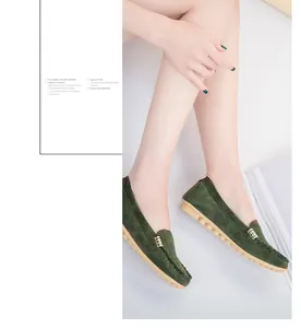 Detailed side view of elegant dark green suede loafers with gold buckle on model