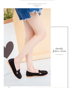 Close-up of black suede loafers with metal buckle and comfortable flat soles