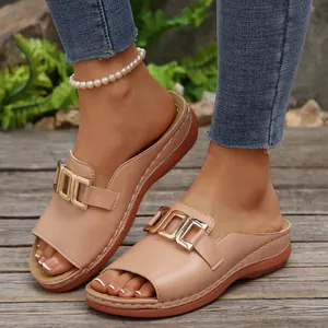 Detailed view of chic beige wedge sandals with gold metal buckle and open toe design