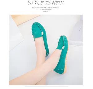 Detailed view of teal green suede loafers for women featuring stylish metal buckle and stitching