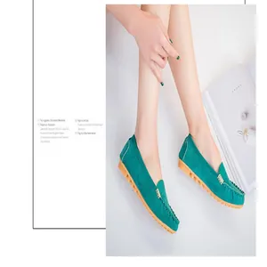 Elegant close-up view of women's green suede loafers featuring a stylish gold buckle detail