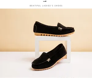 Detailed side view of comfortable black suede women's loafers with gold buckle