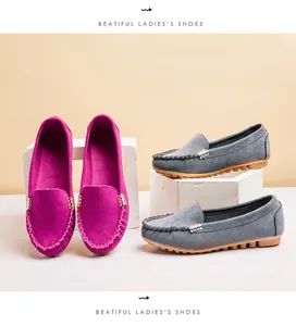 Detail view of stylish round toe suede loafers featuring metal buckle in magenta and grey
