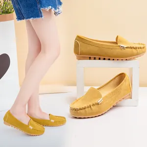 Stylish yellow suede flat loafers with a chic metal buckle decoration for women