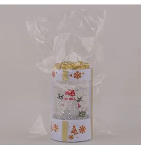 Detailed view of the Christmas snowman snow globe lantern inside its plastic packaging