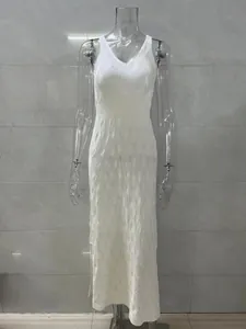 Full view of white sleeveless knitted long dress featuring elegant hollow-out patterns on mannequin