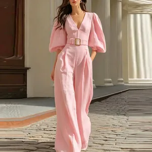 Elegant pink deep V-neck jumpsuit with puff sleeves and belted waist design.