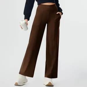 Full view of women's high-waisted brown yoga pants featuring side pockets and straight legs