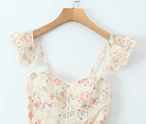 Close-up detail of a floral print dress featuring a sweetheart neck and ruffled straps
