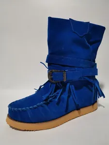Detailed side view of vibrant blue suede fringe boots featuring a classic buckle strap