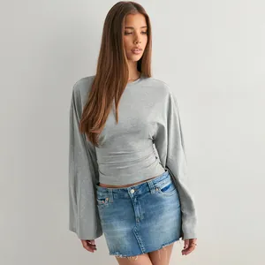 Detailansicht eines grauen Langarmshirts mit weiten Ärmeln und tailliertem Design