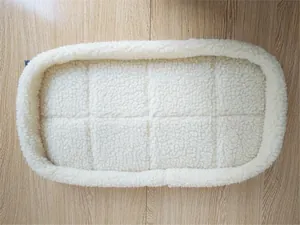 Detail of a soft sherpa fleece pet carrier liner with quilted pattern and raised borders