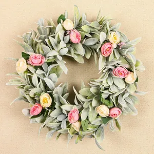 Vue détaillée d'une couronne d'oreilles d'agneau avec des roses roses et crème.