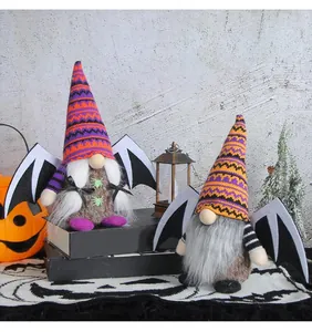 Pair of adorable Halloween gnomes with bat wings and festive knitted hats on display.