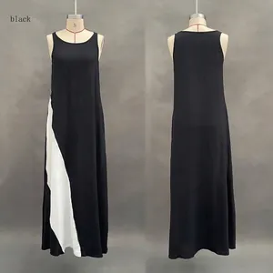 Front and back detail of a loose black sleeveless maxi dress with white color block