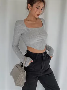 Fashionable grey square neck cropped long sleeve knit top styled with high waist jeans