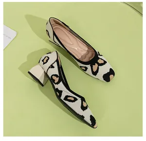 Elegant knit block heel pumps with cream and black leopard pattern and square toe detail.