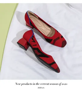 Close-up of red knitted block heel pumps with square toe and stylish black abstract patterns.