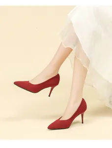 Detailed close-up of elegant dark red pointed-toe knit stiletto pumps worn by a model