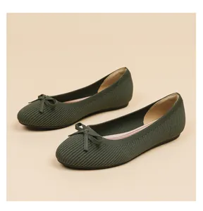 Close-up view of dark olive green knit ballet flats featuring a delicate bow detail