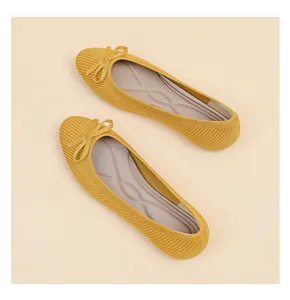 Detailed top view of comfortable yellow knit ballet flats featuring elegant bow accents