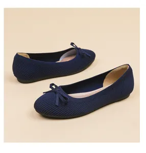 Close-up detail of navy blue knit ballet flats with a classic round toe and bow accent