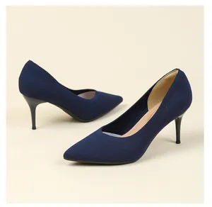 Macro view of navy blue knitted pointed-toe pumps featuring a 7.5cm stiletto heel