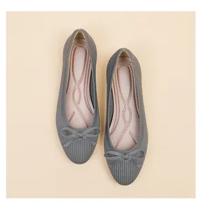 Close-up of grey knitted ballet flats with bow detail and ergonomic insole