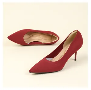 Detail view of red knitted pointed-toe high heels with stiletto heel texture