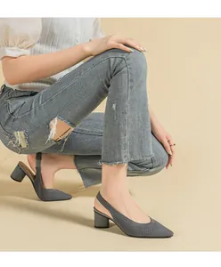 Detailed view of elegant grey knit slingback pumps with pointed toe and block heel.