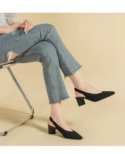 Detail view of black knitted pointed toe slingback sandals with comfortable block heels.